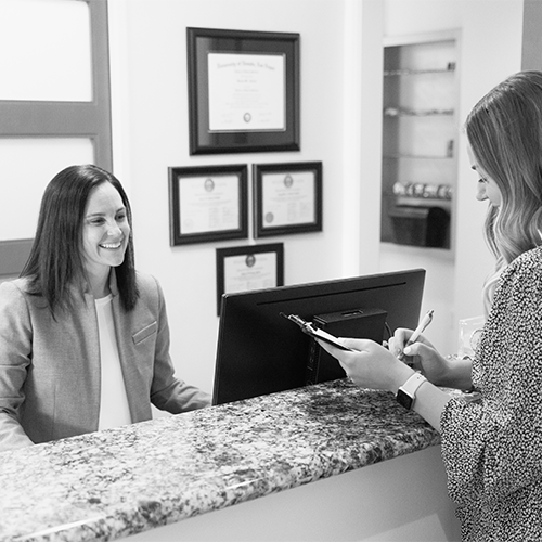 Front office staff member scheduling with a patient.