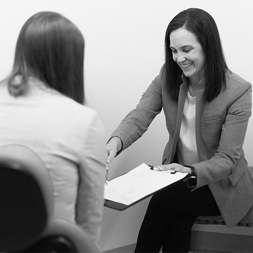 Billing specialist smiling and discussing financing with a patient.